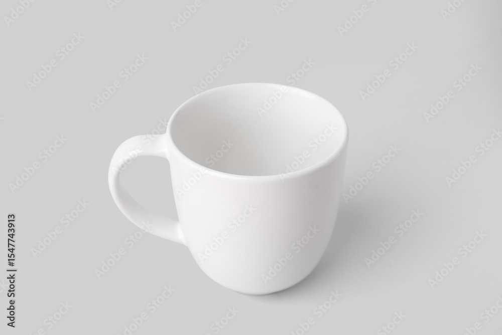 Obraz premium White ceramic cup on grey background
