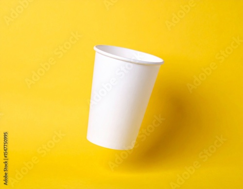 Minimalist mockup of a plain white drinking glass floating on solid yellow background. Clean composition, ideal for branding, advertising, and product design showcase.