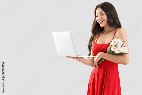 Happy young woman with lapt...
