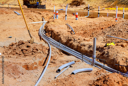Canvastavla Gray electrical pipes lie at construction site ready for installation underground industrial mood