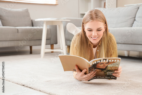 Young blonde woman reading ...