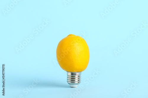 Light bulb with lemon on bl...