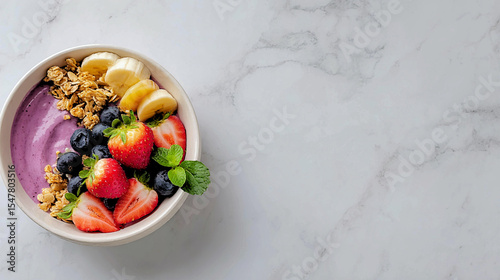 Colorful and refreshing breakfast bowl topped with fruits and granola, perfect for a healthy start to the day