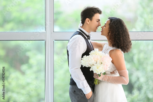 Young couple near window on...