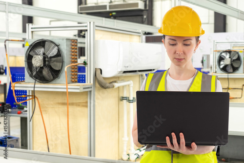 Woman engineer near air con...