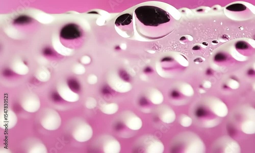 Close-up of  a  pink surface with bubbles and water droplets