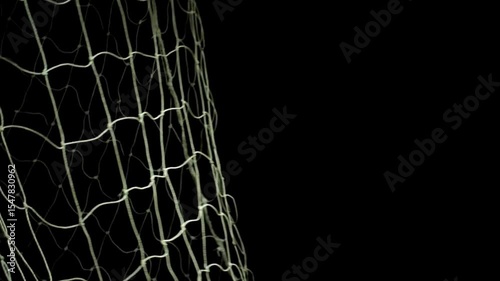 A soccer ball hitting the net during a game, with a dark background highlighting the action