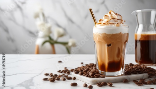tasty iced coffee with whipped cream syrup and beans on white marble table