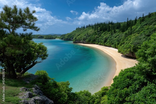 A bay with clear blue water and a sandy beach is framed by lush green vegetation under a partly cloudy sky