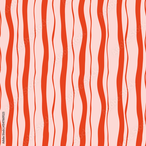 Abstract seamless pattern with wavy vertical stripes in red and light pink tones. Concept of modern textile design, retro aesthetics and creative surface decoration