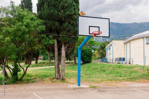 Outdoor basketball hoop in a public park. Urban recreation, sports activity, and healthy lifestyle in a community setting.