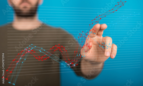 Stock photo of a person interacting with a digital graph showing business growth and decline trends.