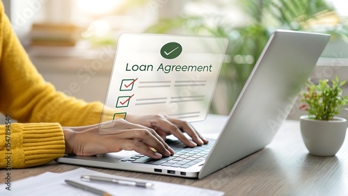 Woman reviewing and approving a digital loan agreement on laptop