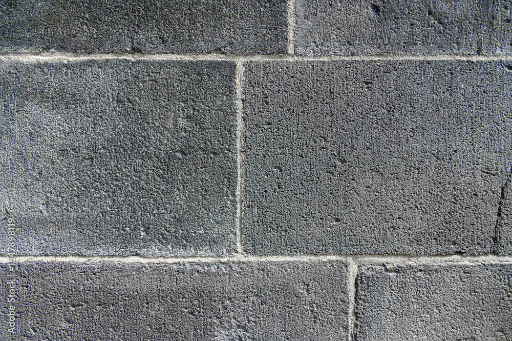 Fototapeta premium Old wall made of large gray blocks. Horizontal photo. Background