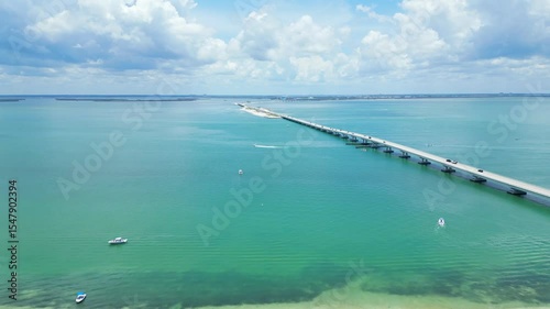 Drone View of sanibel island causeway on clear summer day with blue water and beautiful clouds 