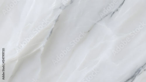 A close up of white marble texture with subtle gray veins running diagonally across the surface area