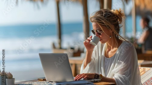 Smiling woman working remotely on a laptop at a tropical beachside café, blending productivity and leisure in a relaxed digital nomad lifestyle.