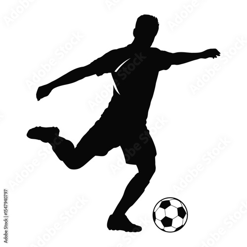 Silhouette of a soccer player kicking a soccer ball