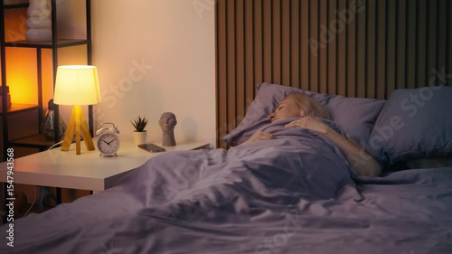 Middle-aged woman sleeping peacefully in bed at night, enjoying healthy rest