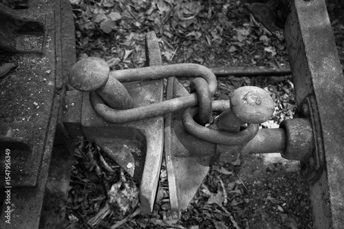 Rusty coupling on abandoned railway tracks showcases forgotten transportation history and nature's slow reclaiming