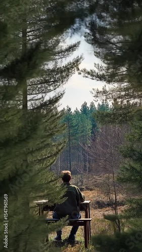 Serene Solo Reflection in the Forest with a Person Sitting at a Bench Amid Nature