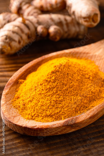 Fototapeta Naklejka Na Ścianę i Meble -  Turmeric with its magnificent orange color on a vintage wooden background	