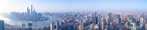 Aerial view of Shanghai skyline with winding river at sunrise.