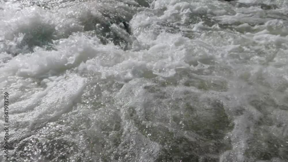 Slow motion moving shot above a clear rocky mountain river. Calm and peaceful atmosphere for relaxation. Ecological and environmental concept. 4K footage