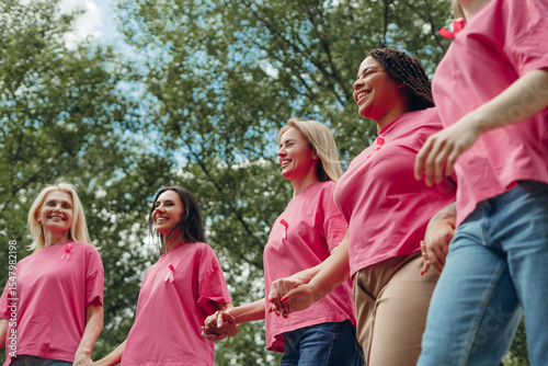 Photos Women holding hands and wearing pink ribbons are walking for breast cancer aware