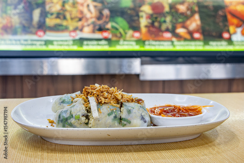 Fresh Vietnamese Spring Rolls with Pork on a table in a fast food restaurant with offer of menu on a background, Bangkok, Thailand