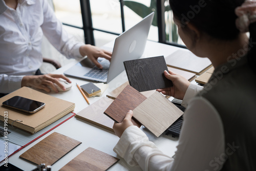 Interior designer presenting eco friendly wooden material samples for sustainable home decor