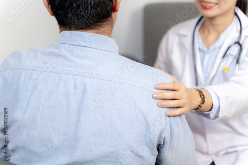 Compassionate doctor placing hand on patient’s shoulder, offering emotional support and encouragement.
