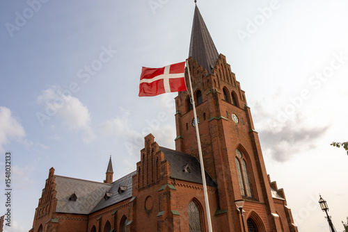 Nykobing Mors, Denmark  The Nykoping Mors Church, the Sankt Clemens Kirke,  and a Danish flag.