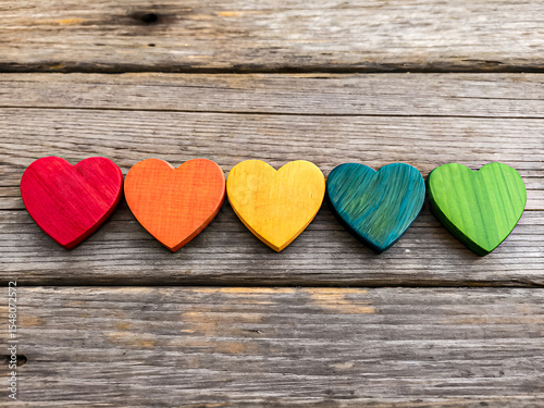 Colorful Wooden Hearts on Rustic Background