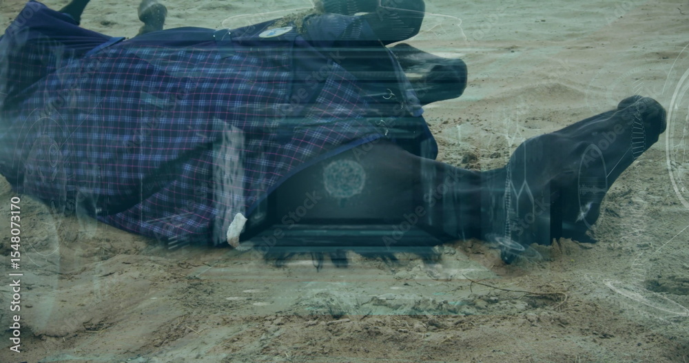 Naklejka premium Lying face-down adult wearing plaid coat with tactical boots on desert shore with tech HUD overlays