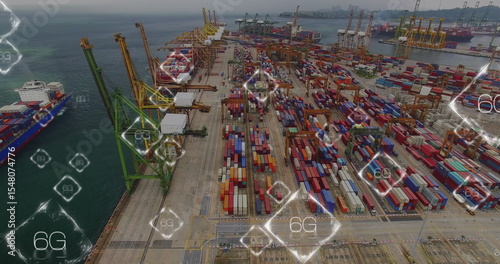Showing aerial port quay with containers, gantry cranes and container ships under digital 6G icons