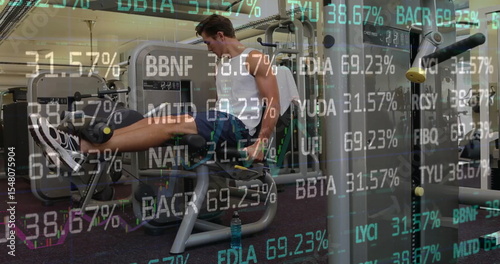 Extending legs on leg extension machine at fitness center wearing sportswear and financial overlays