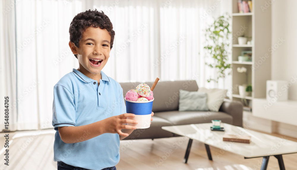Boy holding an ice cream in a cup Boy holding an ice cream in a cup