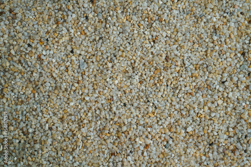 Pebble background. Beautiful creative natural background with visible little pebbles texture and rough uniform structure. Pebbles on the ground. Rough texture, construction material background