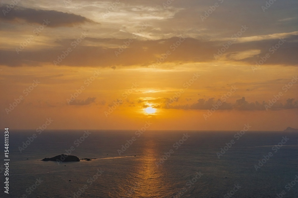 Fototapeta premium Beautiful sunset on Andaman sea at Windmill View Point near Laem Promthep Cape, Phuket, Thailand
