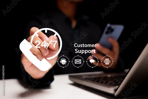 A person using a smartphone and laptop with digital icons representing 24/7 customer support services.