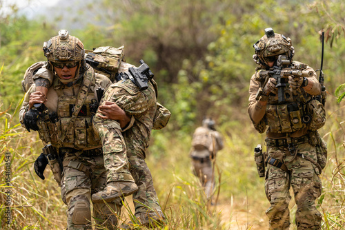 Fotografi Soldier Carrying Injured Comrade During Tactical Combat Mission – Military Rescu
