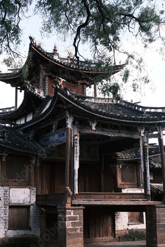 This is the ancient stage in Shaxi Ancient Town, Yunnan,China. With traditional Chinese architecture, carved beams and elegant eaves, it stands under trees, full of historic charm.