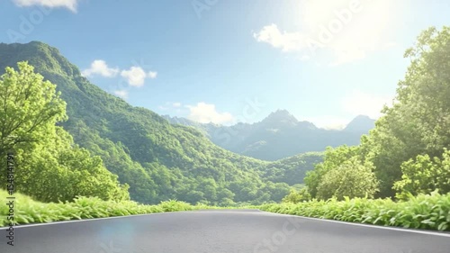 Road Through the Mountain Scenery: An empty road winding through a picturesque mountain landscape, showcasing the breathtaking beauty of nature with lush greenery under a vibrant blue sky.