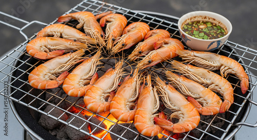 A fresh prawn grilling on a grill with hot chacoals.