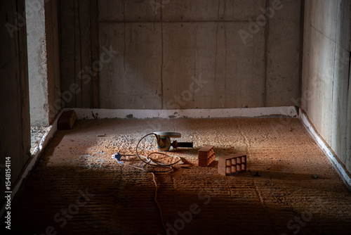 Angle grinder resting on freshly cut bricks at a construction site, showcasing power tool use and building materials in a work-in-progress setting.