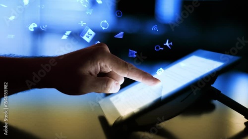 Close Up on Person's Hands Using a tablet Computer with Several Icons Presented in Futuristic Holographic Visualization. Anonymous Man Working on Dark Modern Office.