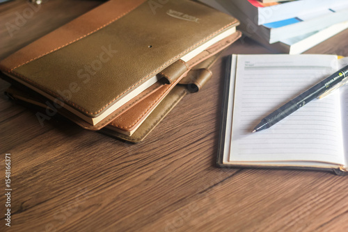 Several stacks of books and pencils are on the wooden table, education concept