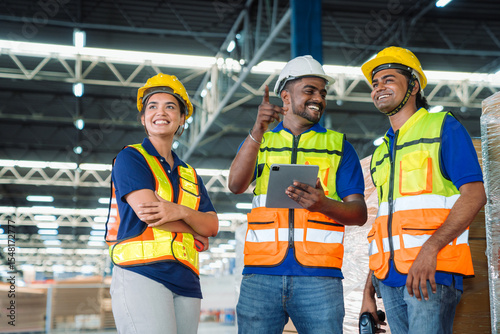 Diverse workfoce team black men,woman factory worker wear safety helmet, safety vest use tablet for industrial warehouse job.Teamwork efficient success modern logistic manufacture operation management