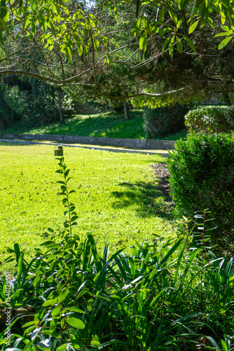 Lush green garden inside the historic walls of Évora, Portugal. Tranquil scene with manicured lawn and medieval charm, perfect for travel and heritage concepts.